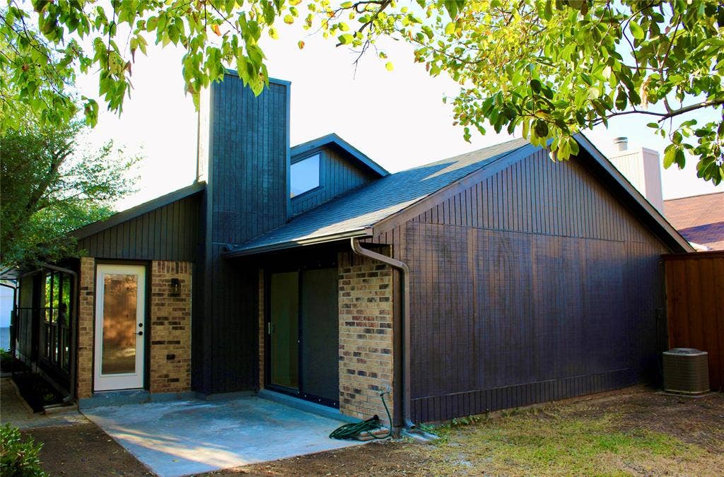 3706 Aries Drive, Garland, TX 75044 Contemporary exterior featuring vertical siding and brick accents