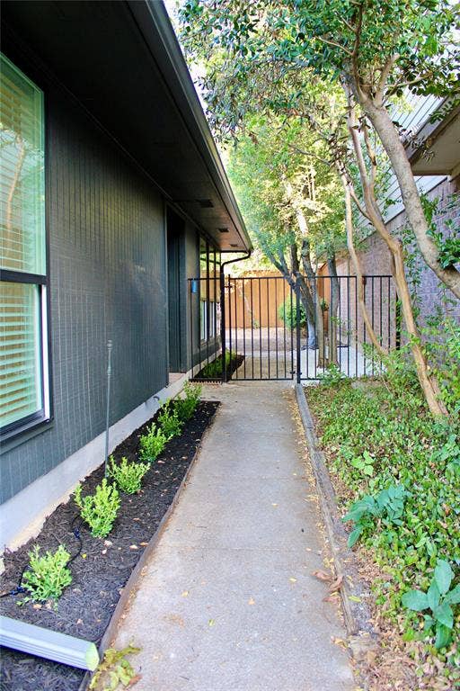 3706 Aries Drive, Garland, TX 75044 Paved walkway, landscaping with planted shrubs, and mature trees