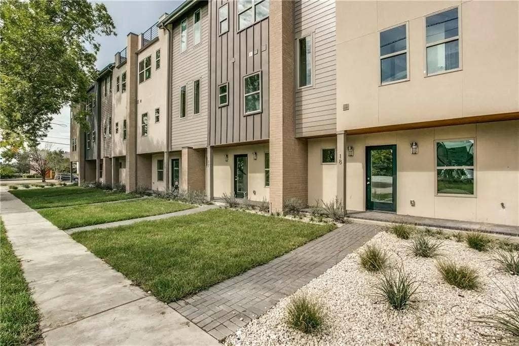 4303 Cole Avenue, #17, Dallas, TX 75205 Contemporary townhome exterior with mixed material facade, paver stone walkway, mature landscaping, and an opaque glass-paneled entry door