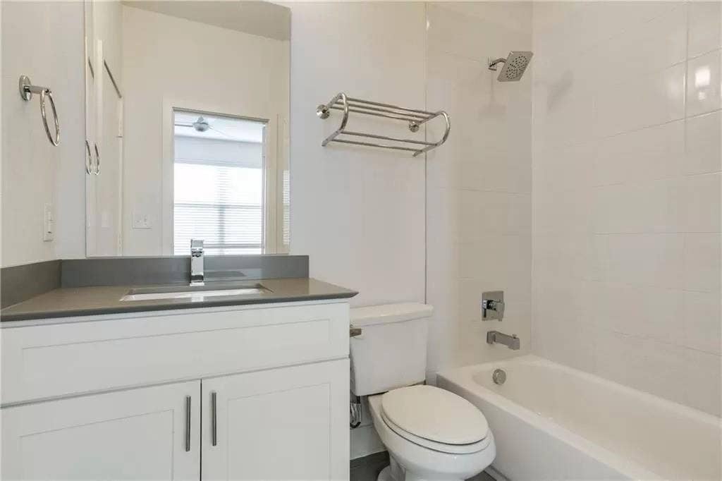 4303 Cole Avenue, #17, Dallas, TX 75205 White vanity with integrated sink, sleek countertop, and chrome faucet