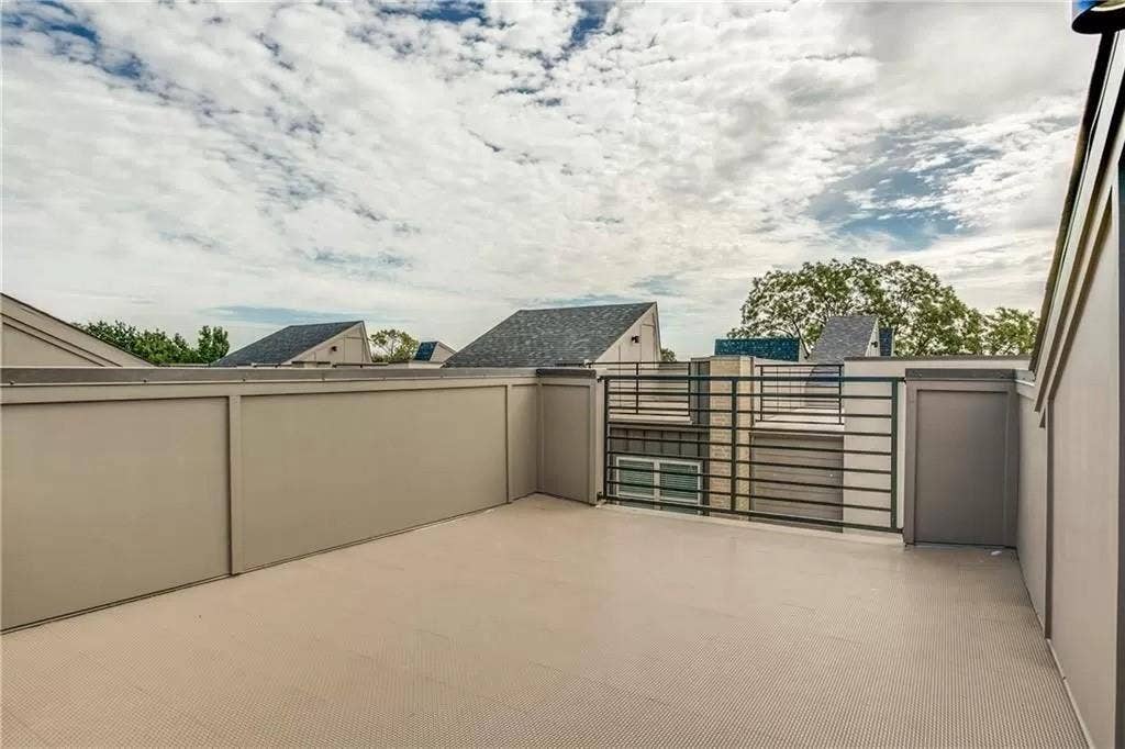 4303 Cole Avenue, #17, Dallas, TX 75205 Rooftop patio with a textured surface, surrounded by privacy walls and a black metal railing