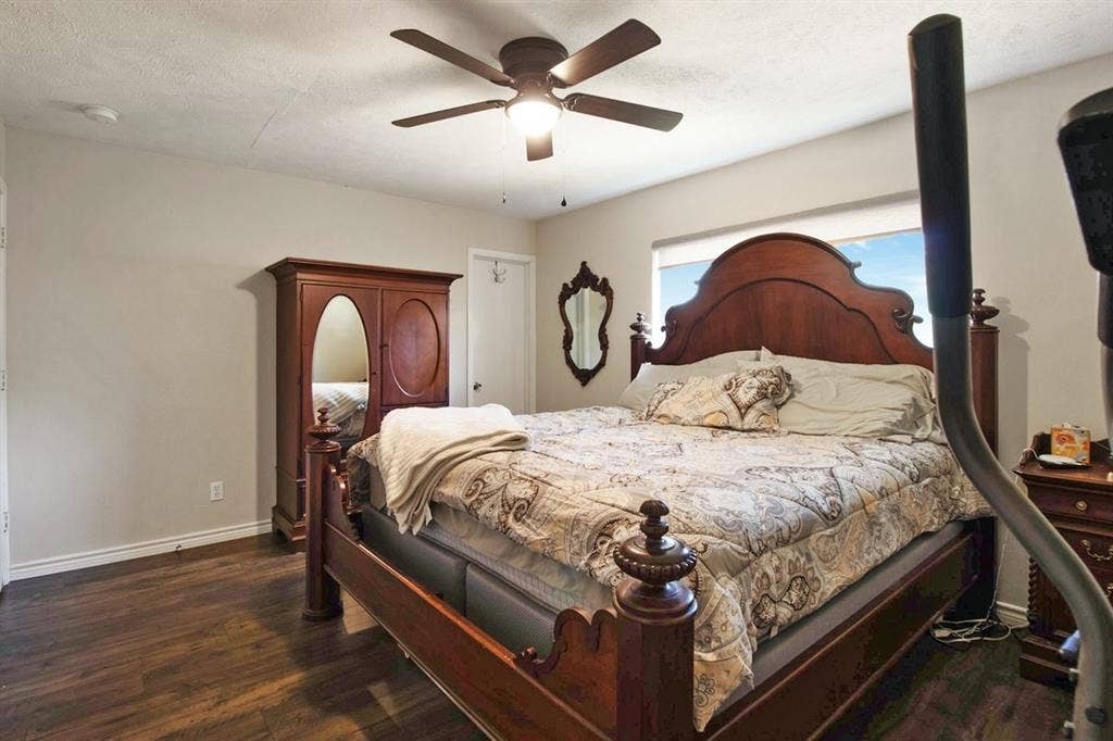 4026 Salem Drive, Garland, TX 75043 Primary bedroom with large window and ceiling fan.
