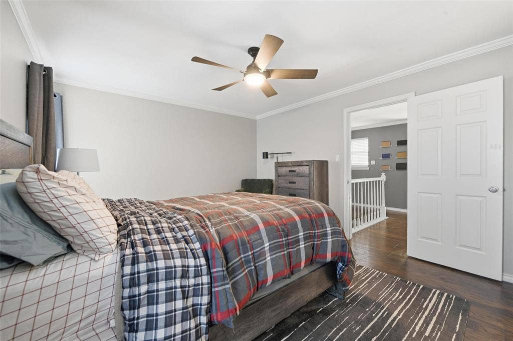 Recessed lighting and a ceiling fan fixture illuminate the room