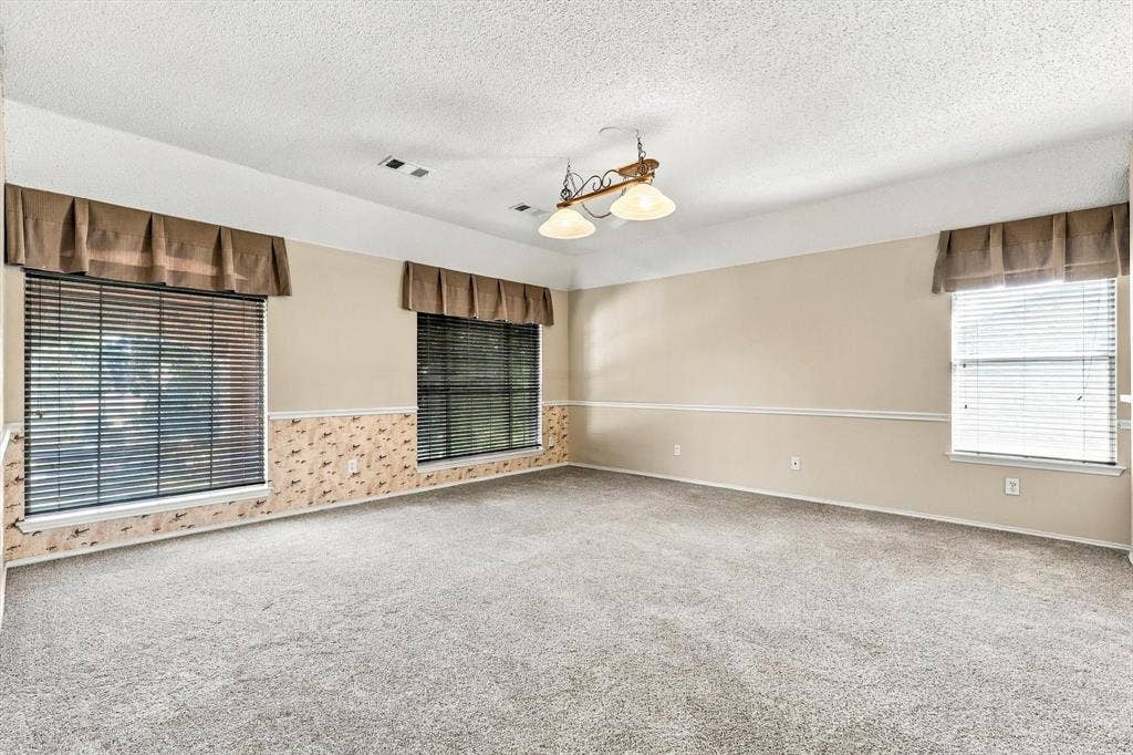 103 Deerpath Road, Hickory Creek, TX 75065 Carpeted interior with light-toned walls, multiple windows with blinds, and a central ceiling light fixture