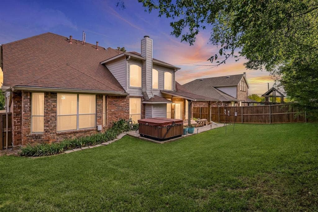 103 Deerpath Road, Hickory Creek, TX 75065 Expansive backyard with a manicured lawn, brick and siding exterior, a covered patio area, and a privacy fence