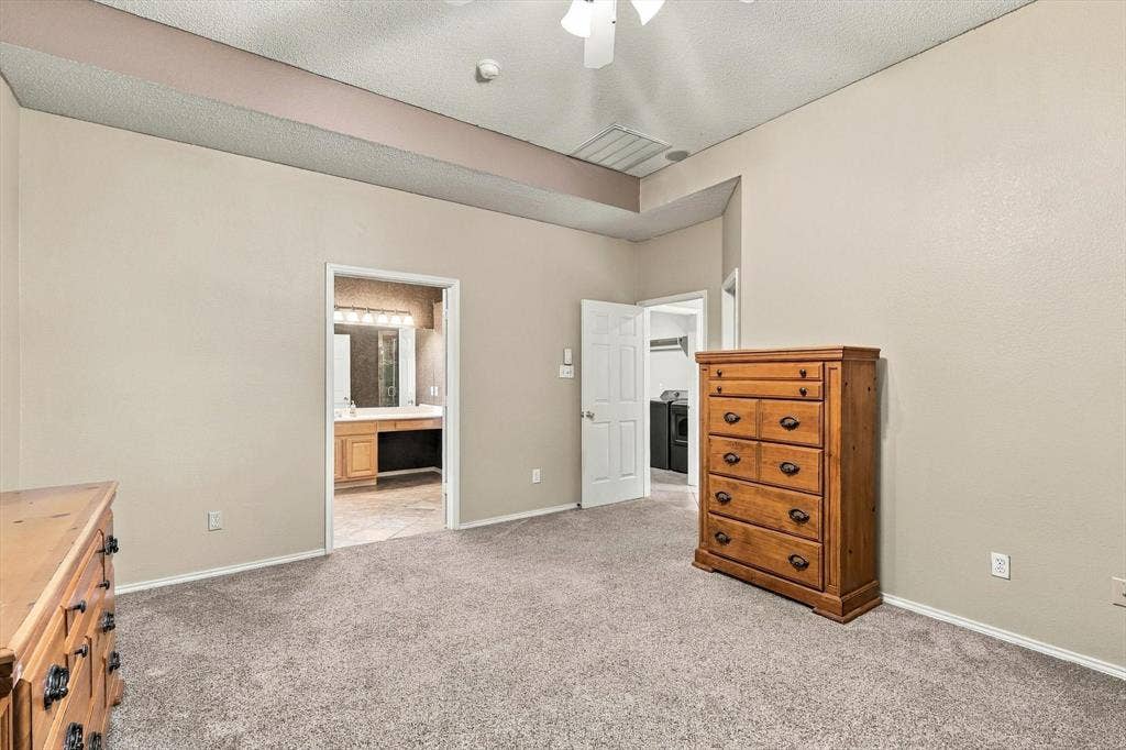 103 Deerpath Road, Hickory Creek, TX 75065 Plush carpeted flooring, vaulted ceiling, ceiling fan with light fixture, and neutral wall tones