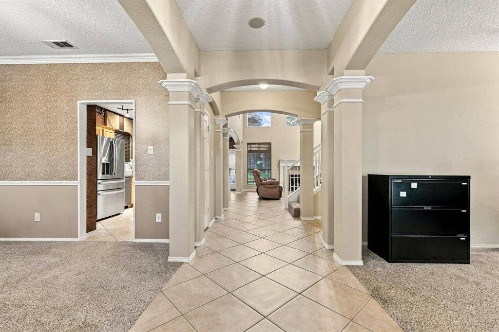 103 Deerpath Road, Hickory Creek, TX 75065 Archway entry with decorative columns leading to a tiled corridor