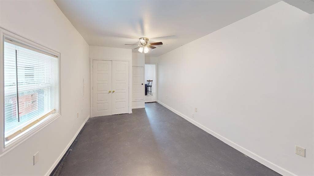 1710 Meridian Way, Garland, TX 75040 Spacious room featuring a ceiling fan, window with horizontal blinds, and a pair of white paneled closet doors