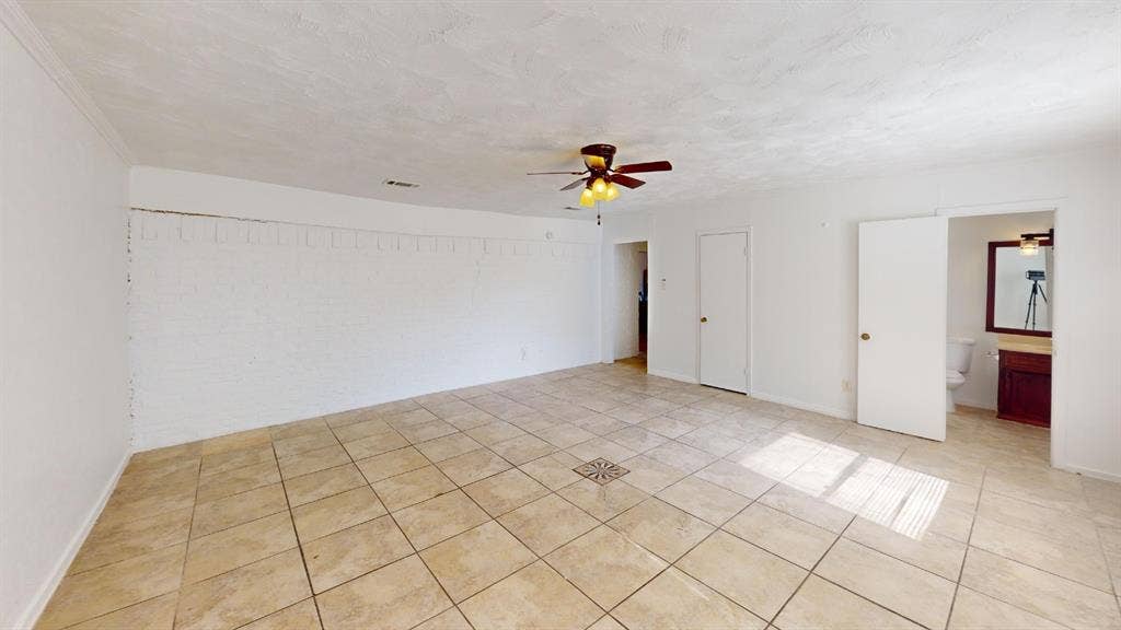 1710 Meridian Way, Garland, TX 75040 Spacious room featuring tile flooring, a ceiling fan with integrated lighting, and white painted walls