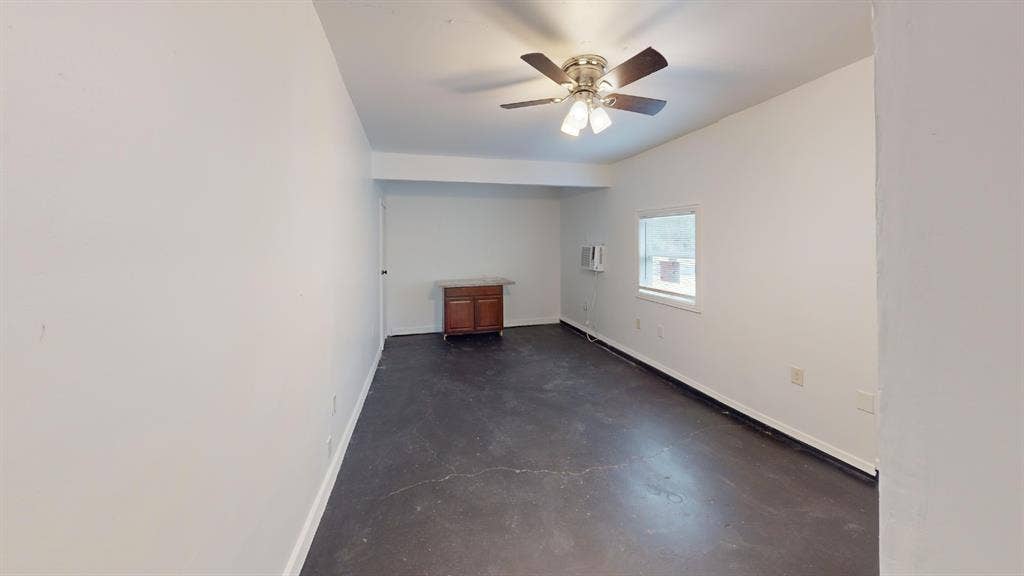 1710 Meridian Way, Garland, TX 75040 Ceiling fan, window, built-in wooden cabinetry, white walls, and dark flooring