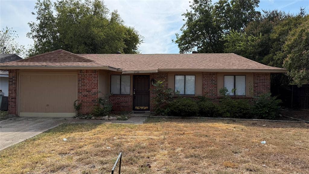 1710 Meridian Way, Garland, TX 75040 Brick facade with an attached garage, a brown shingle roof, and established front landscaping