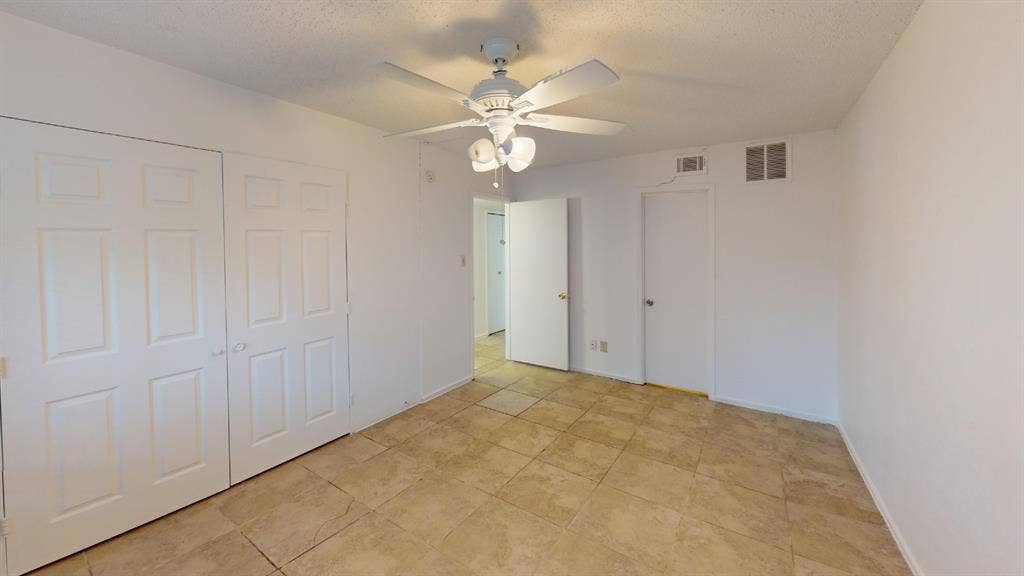 1710 Meridian Way, Garland, TX 75040 Tile flooring, white walls, ceiling fan with light fixture, white interior doors, and a white six-panel bi-fold closet door