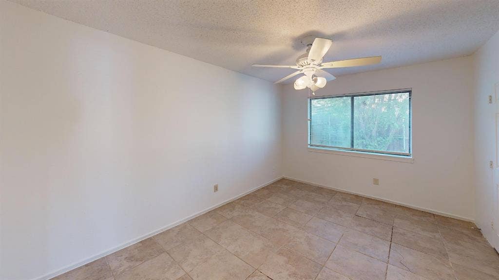 1710 Meridian Way, Garland, TX 75040 Neutral wall color, ceramic tile flooring, ceiling fan with integrated lighting, and a double-pane window