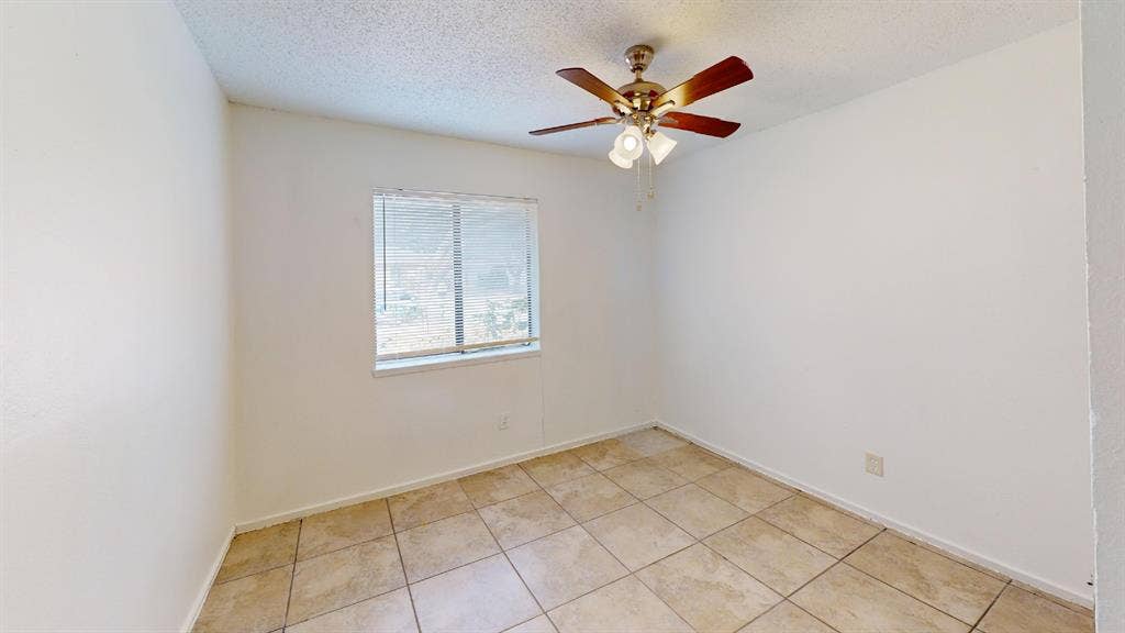1710 Meridian Way, Garland, TX 75040 Neutral wall color, window with blinds, ceiling fan with integrated lighting, and tile flooring