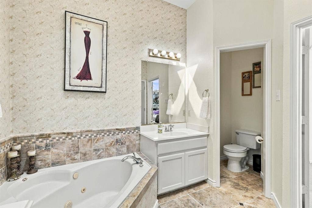 Built-in jetted tub with tiled surround and decorative accent border