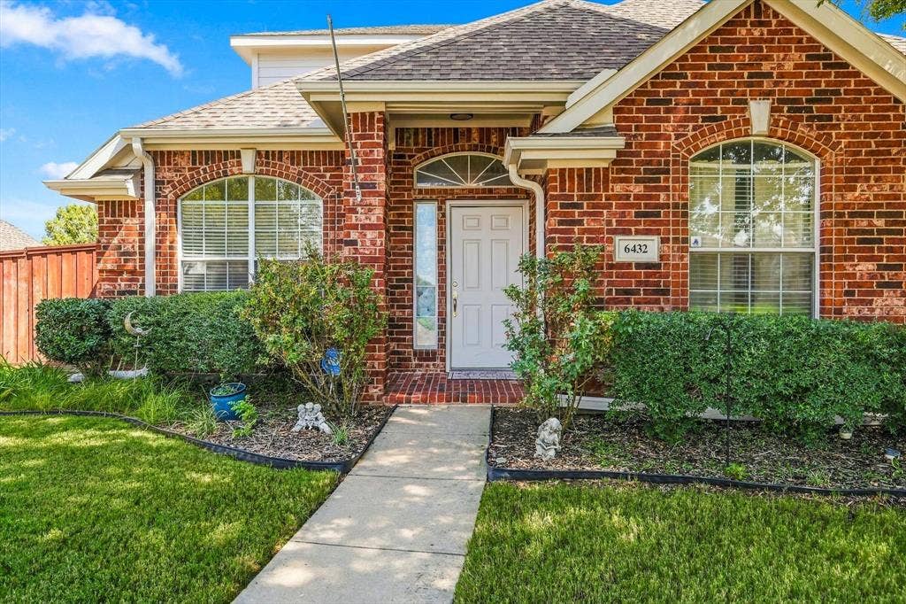 Brick exterior with an arched window and white trim