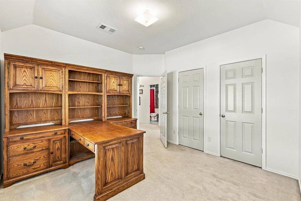 Built-in wood-finish desk with integrated shelving and cabinetry