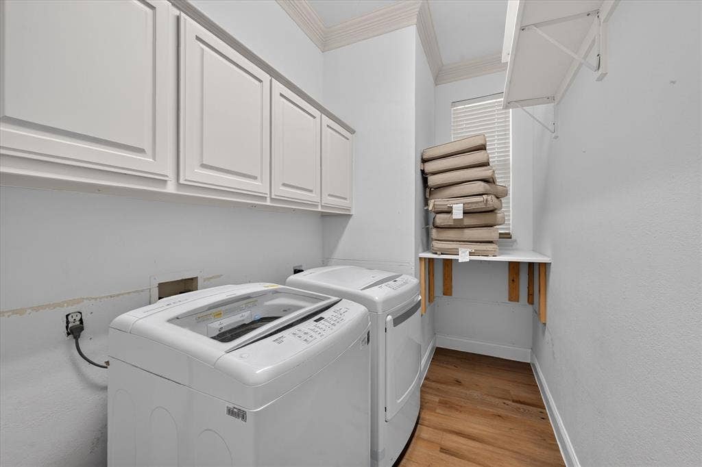 10601 Whispering Pines Drive, Frisco, TX 75033 White shaker-style cabinetry, wood-finish flooring, a window with blinds, and a built-in folding shelf