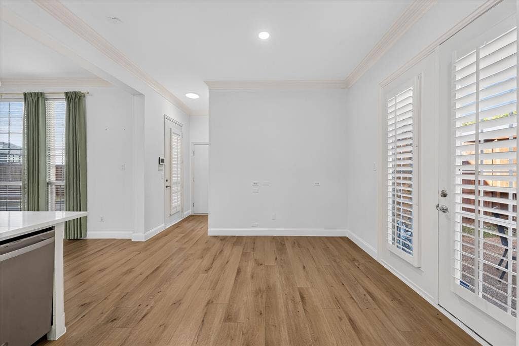 10601 Whispering Pines Drive, Frisco, TX 75033 Wood-finish flooring, recessed lighting, crown molding, double French doors with plantation shutters, and a built-in kitchen appliance