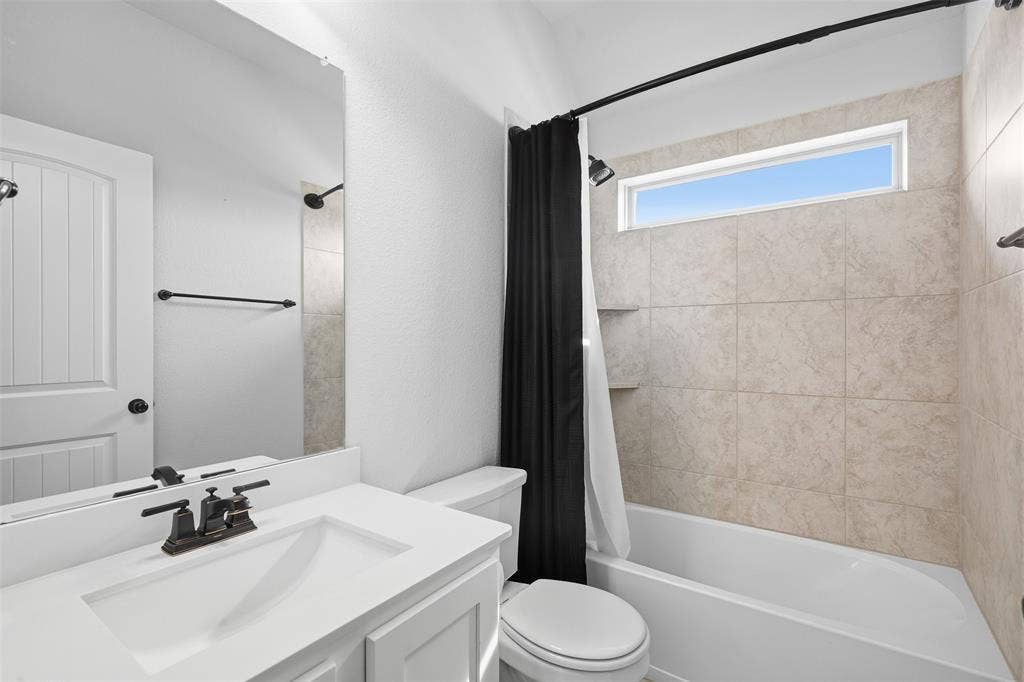 White vanity with integrated rectangular sink and oil-rubbed bronze faucet