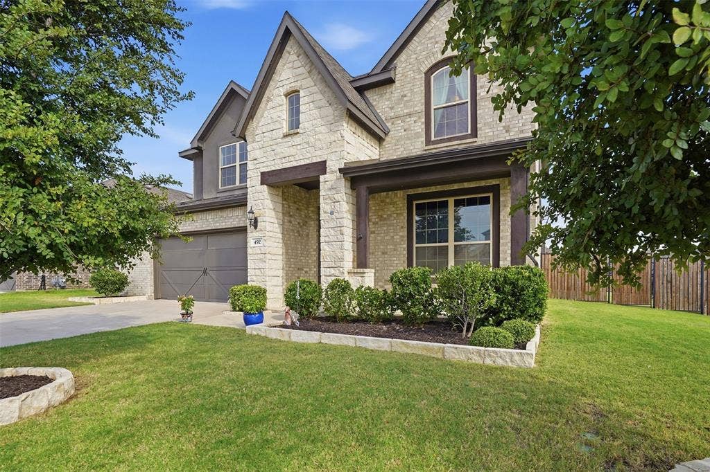 Stone and stucco exterior with gabled roof lines