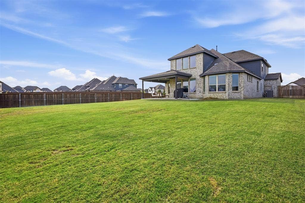 Expansive green space with wood fencing