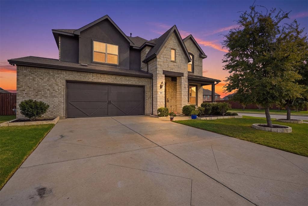 Stone and brick facade with a two-car garage