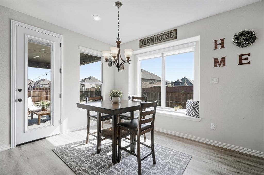 Recessed ceiling lighting, wood-finish flooring, white trim, and a glass-paneled exterior door