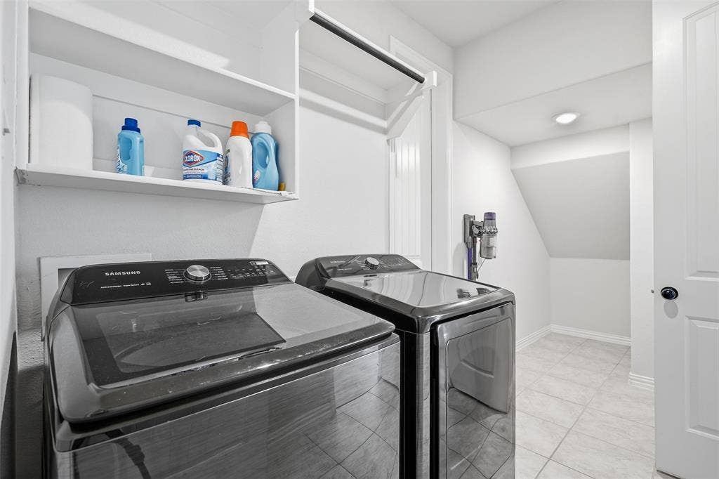 Laundry area with tile flooring, built-in shelving, and a hanging rod