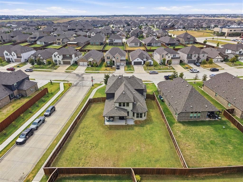 Expansive fenced backyard with a patio
