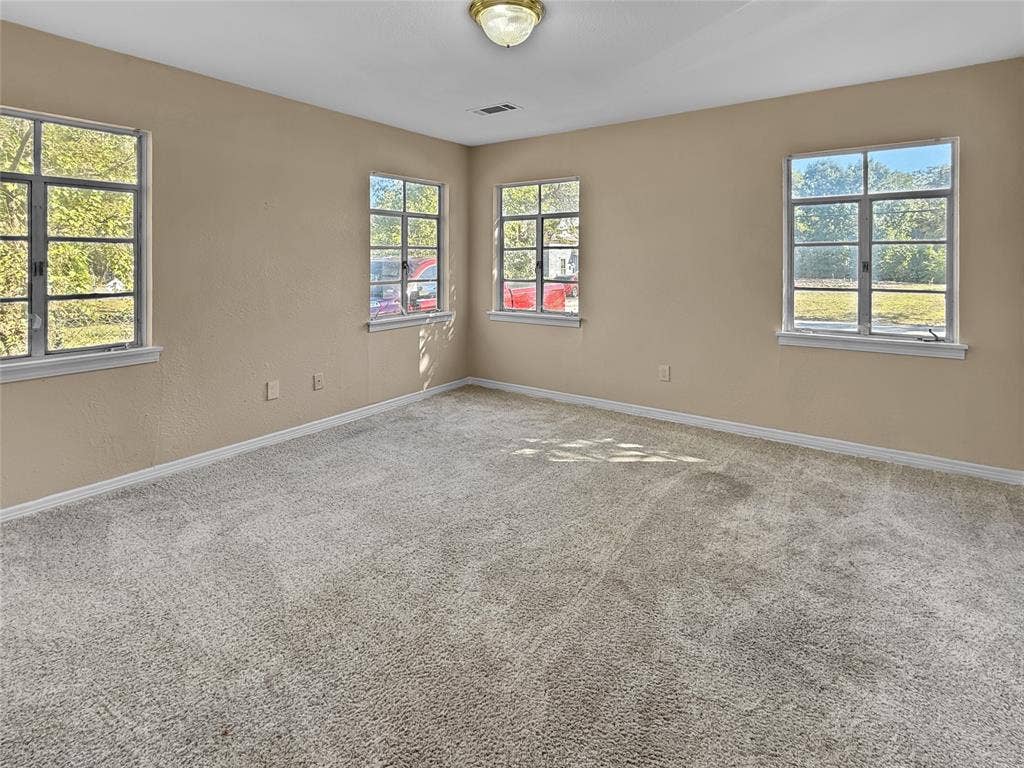 Neutral-toned walls complement plush carpet flooring