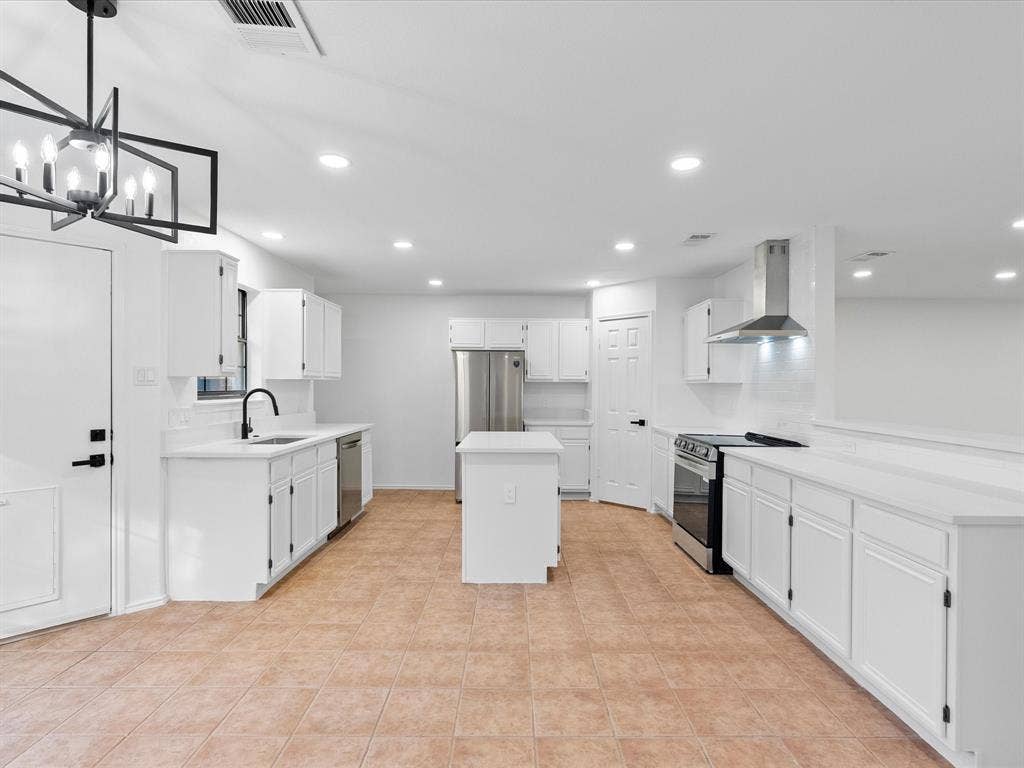 6716 Gold Dust Trail, Dallas, TX 75252 Kitchen featuring white cabinetry, stainless steel appliances, a center island, recessed lighting, and tile flooring