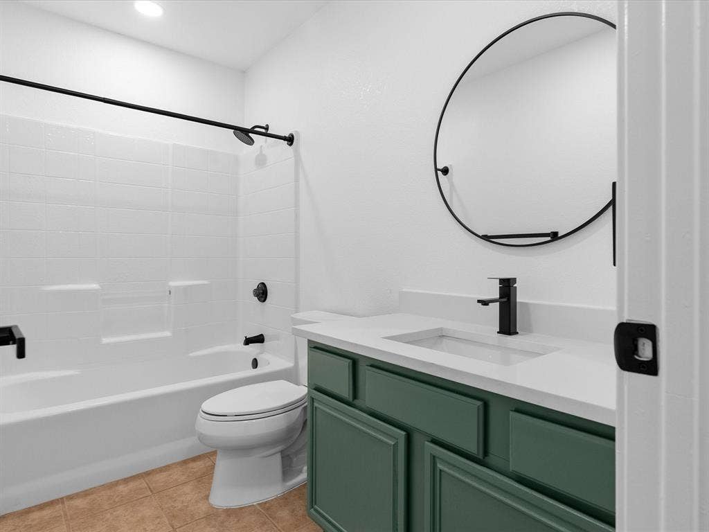 6716 Gold Dust Trail, Dallas, TX 75252 White tub and shower combination with dark-finished fixtures