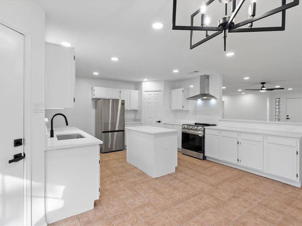 6716 Gold Dust Trail, Dallas, TX 75252 Updated kitchen featuring white shaker cabinetry, stainless steel appliances, a center island, and recessed lighting