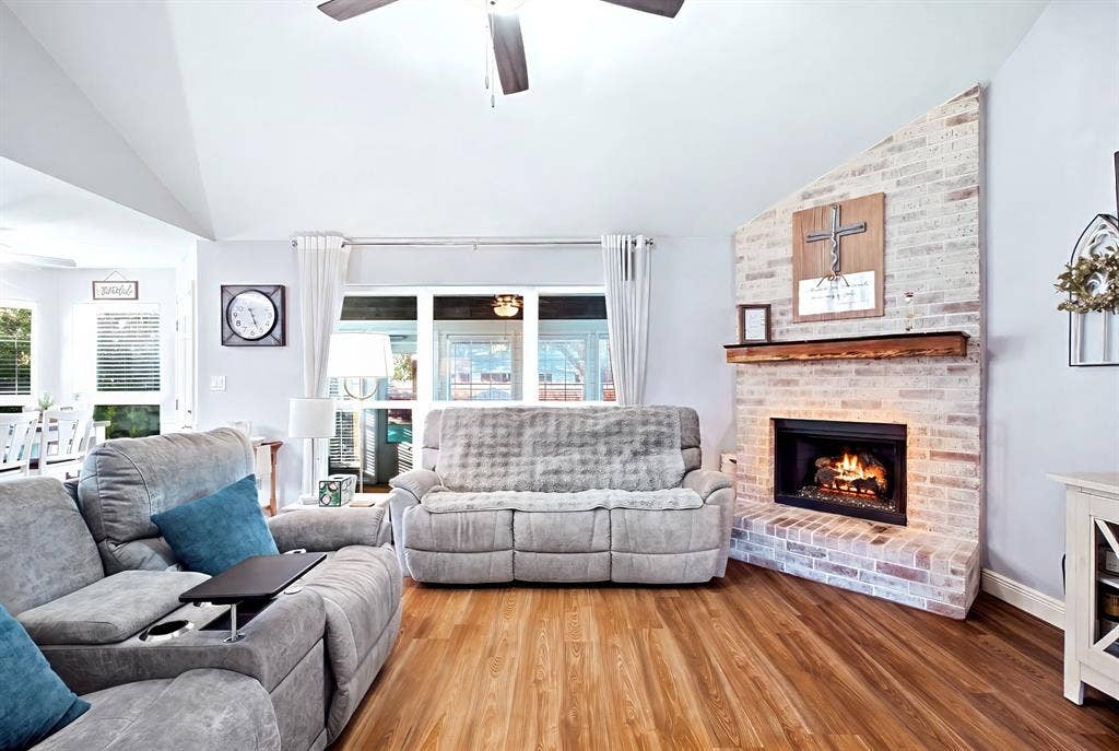 506 Amy Jo Circle, Aubrey, TX 76227 Vaulted ceiling, wood-finish flooring, brick fireplace with a wood mantel, and expansive windows