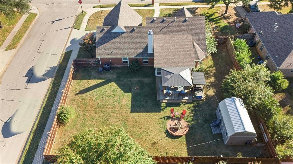 506 Amy Jo Circle, Aubrey, TX 76227 Expansive backyard with a privacy fence, wood deck, freestanding gazebo, and a storage shed