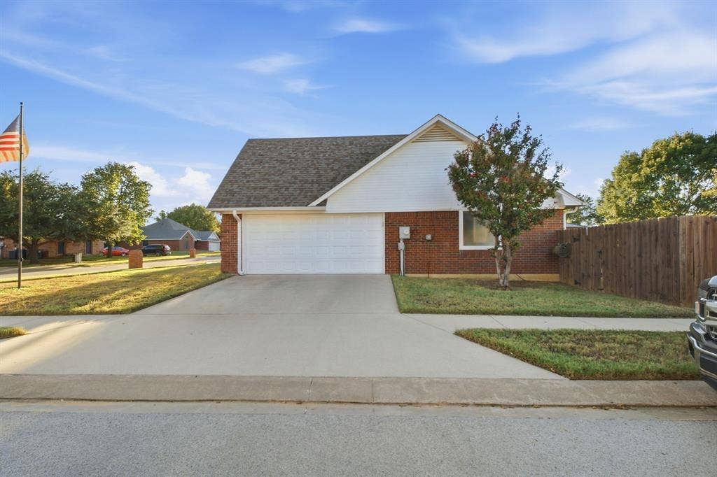 506 Amy Jo Circle, Aubrey, TX 76227 Brick and siding exterior with a pitched roof, attached garage, concrete driveway, and a fenced side yard