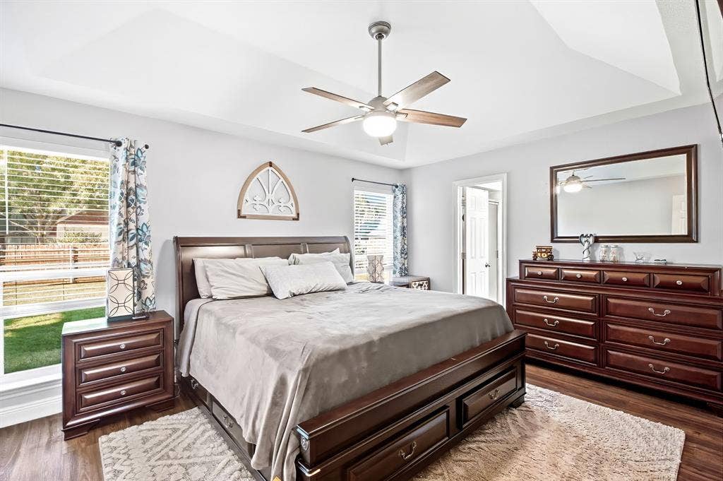 506 Amy Jo Circle, Aubrey, TX 76227 Tray ceiling, ceiling fan with light, wood-finish flooring, two large windows, and an interior doorway