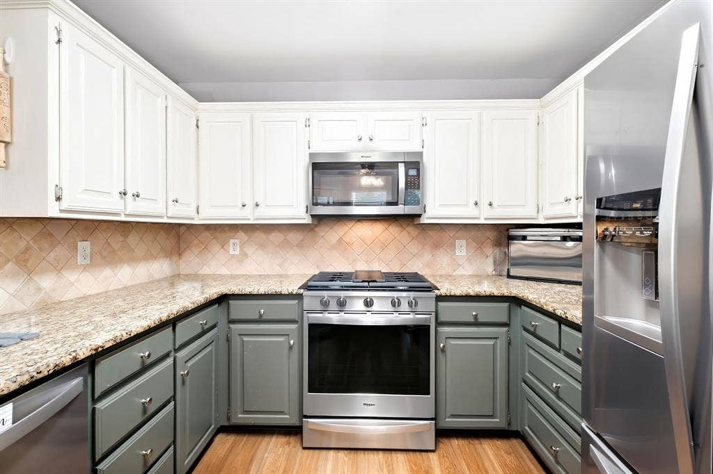 506 Amy Jo Circle, Aubrey, TX 76227 Kitchen featuring two-tone cabinetry, granite countertops, tile backsplash, and stainless steel appliances