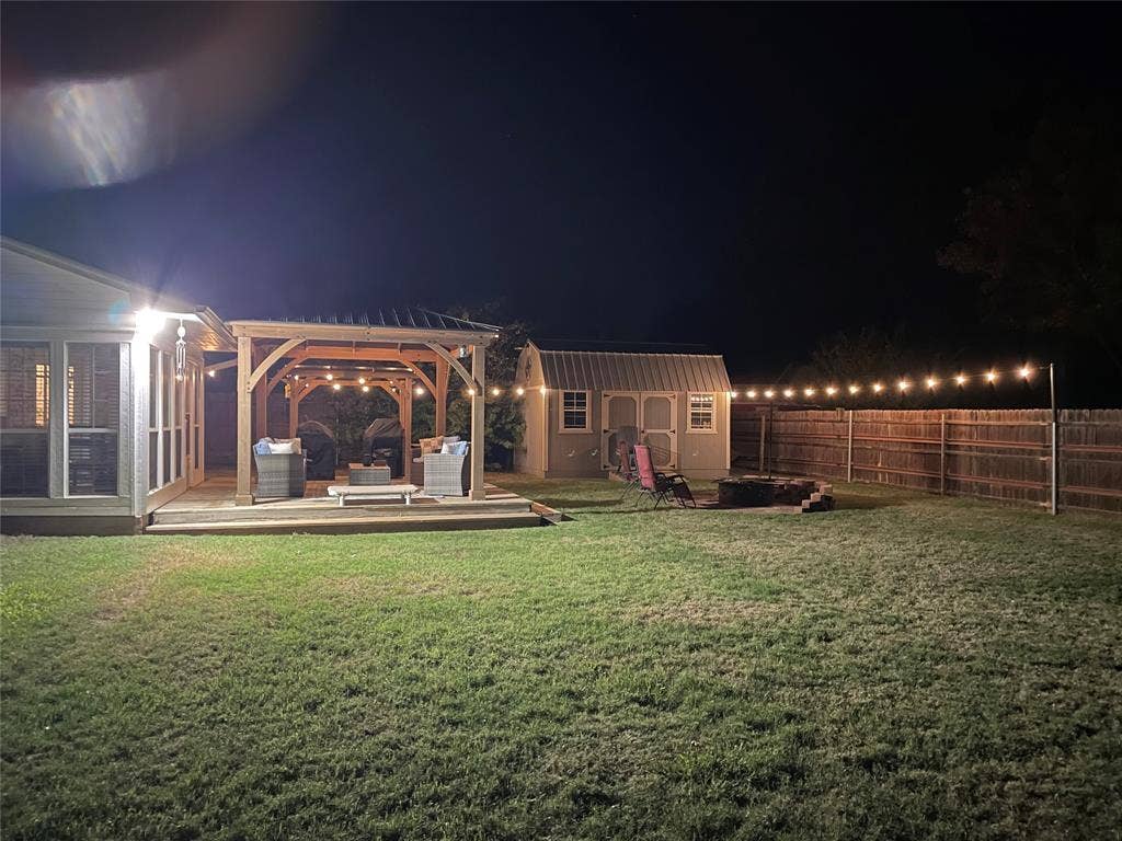 506 Amy Jo Circle, Aubrey, TX 76227 Expansive grass lawn with a wooden privacy fence