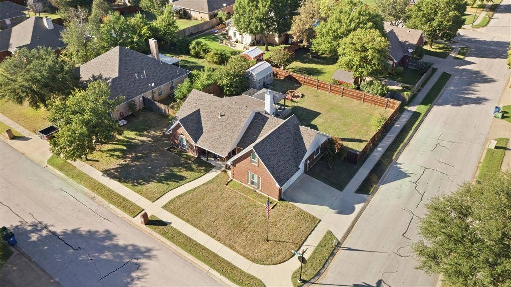 506 Amy Jo Circle, Aubrey, TX 76227 Brick exterior home with an attached garage, fenced backyard, and mature trees