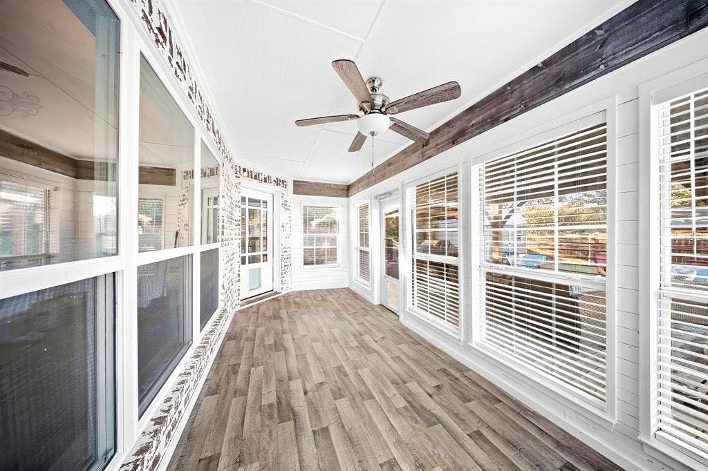 506 Amy Jo Circle, Aubrey, TX 76227 Enclosed porch featuring wood-finish flooring, white paneled walls, multiple windows with blinds, and a ceiling fan with light fixture