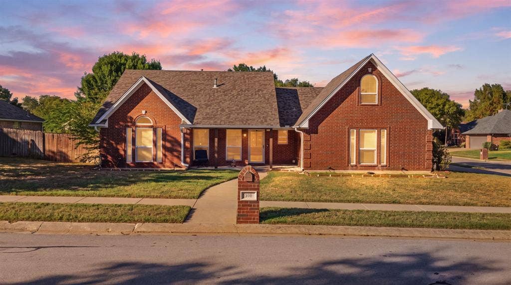 506 Amy Jo Circle, Aubrey, TX 76227 Brick exterior with a gabled roofline, arched window details, and an integrated mailbox
