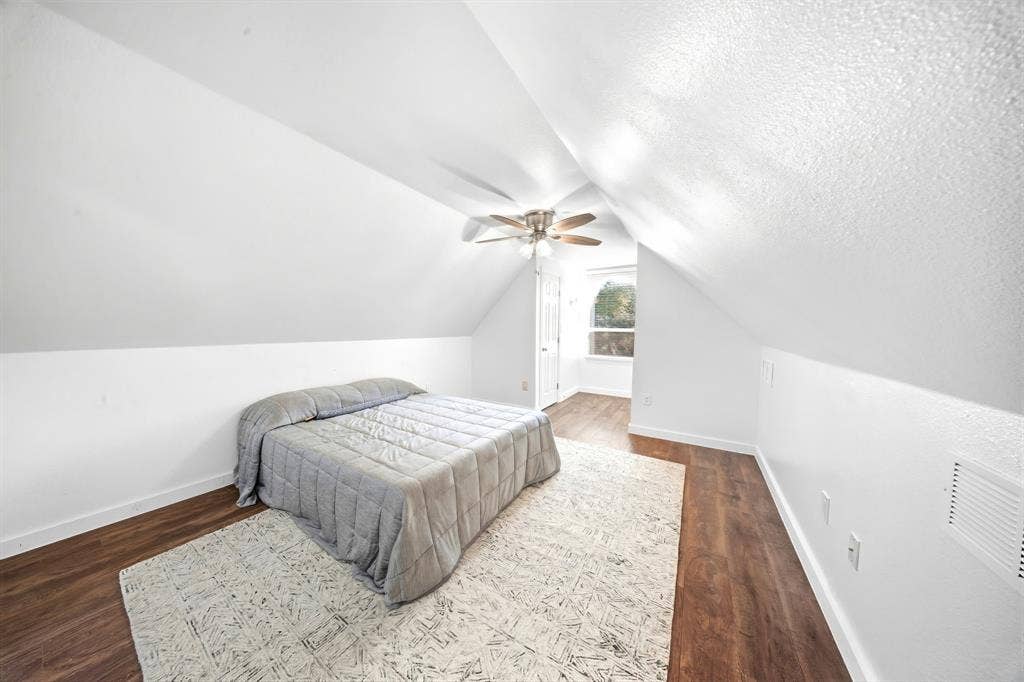 506 Amy Jo Circle, Aubrey, TX 76227 Virtually Staged Bedroom or Bonus RoomSlanted ceilings create architectural interest in this room featuring wood-finish flooring, a ceiling fan, and a window