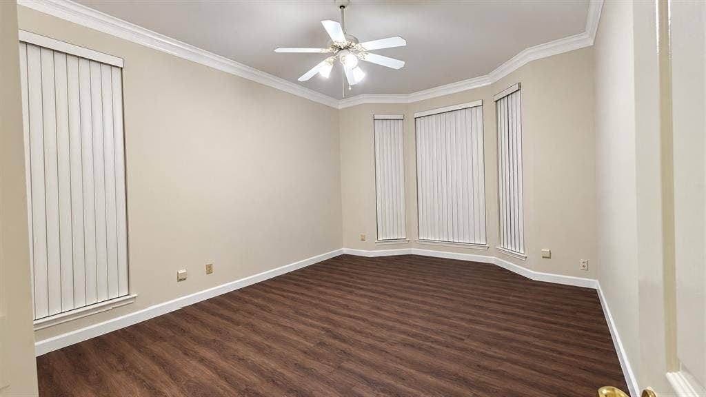 Recessed bay window, crown molding, wood-finish flooring, ceiling fan with light kit, vertical blinds