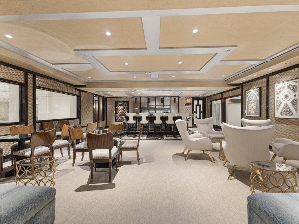 2300 Wolf Street, #14A, Dallas, TX 75201 Recessed lighting, layered ceiling design, built-in bar, patterned wall panels, and interior windows