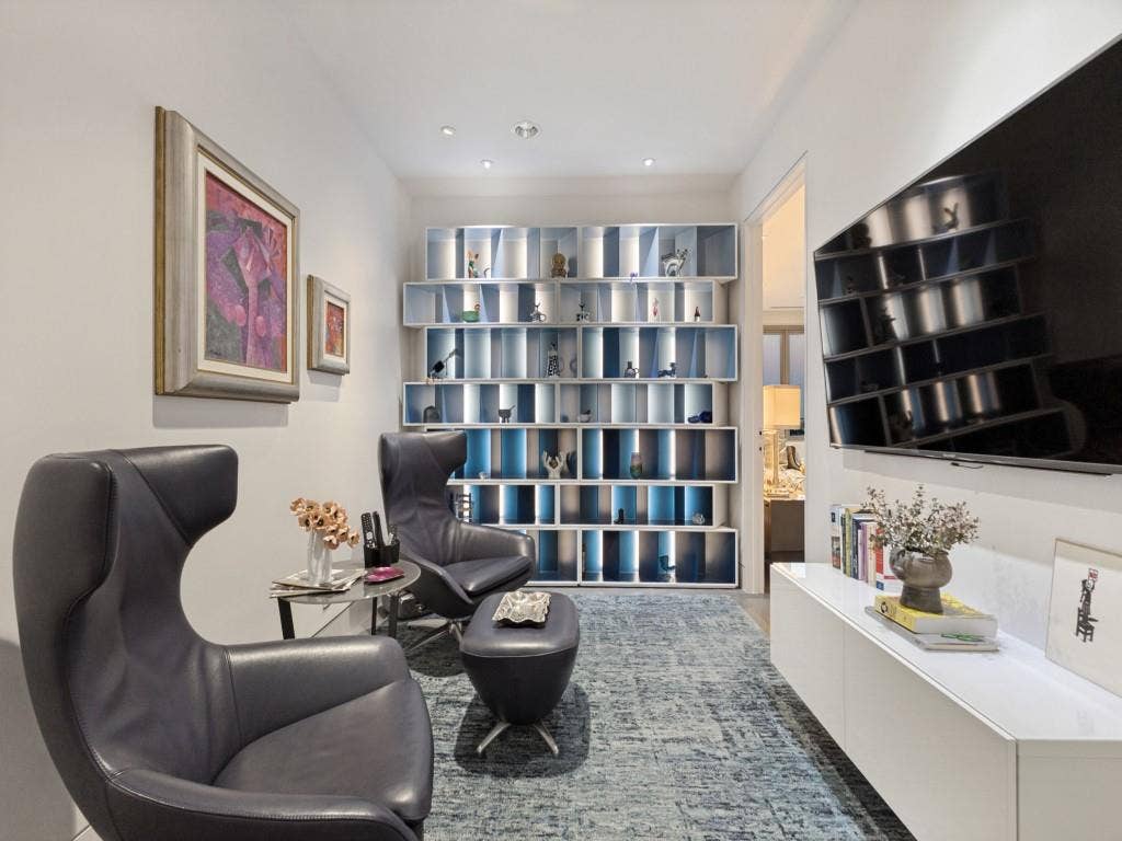 2300 Wolf Street, #14A, Dallas, TX 75201 Recessed lighting, built-in shelving with integrated lighting, wall-mounted display, and a wall-mounted media console