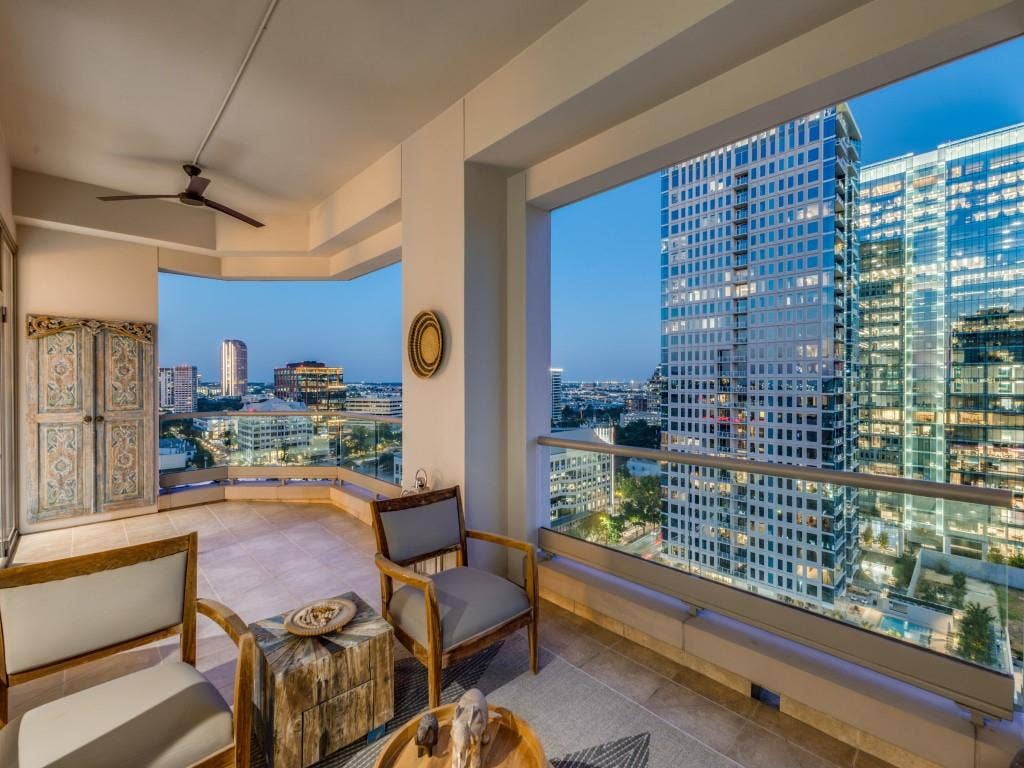 2300 Wolf Street, #14A, Dallas, TX 75201 Tiled outdoor balcony with glass railing, providing expansive cityscape scenery