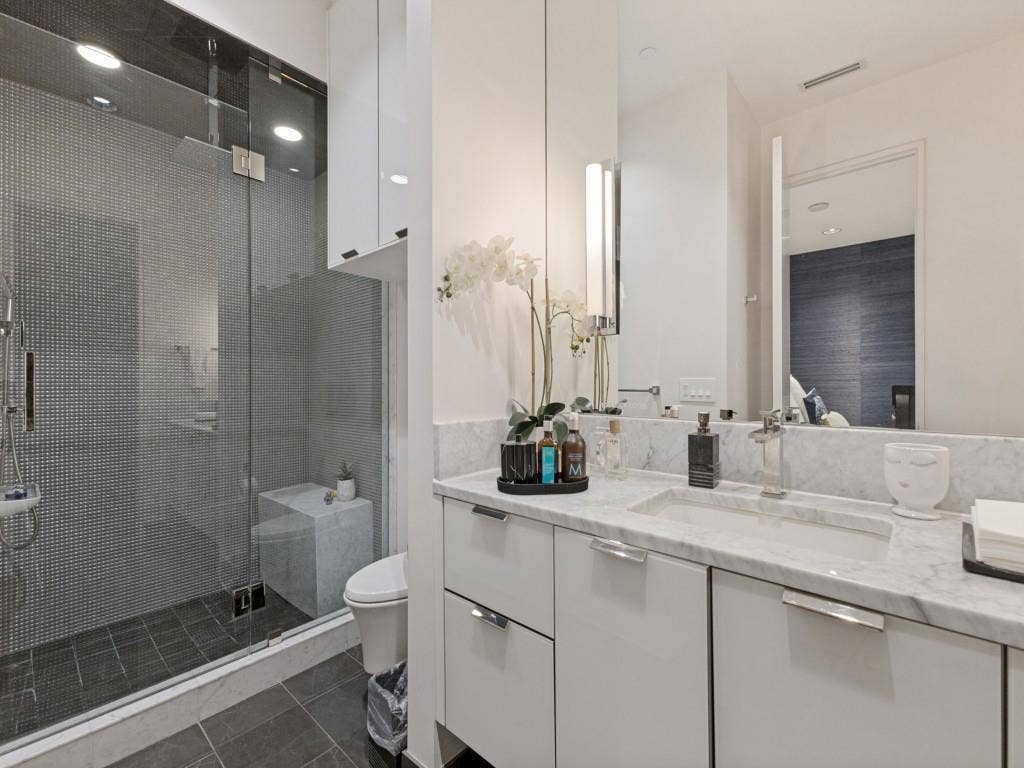2300 Wolf Street, #14A, Dallas, TX 75201 Vanity with a polished stone countertop, integrated rectangular sink, and chrome-finish fixtures
