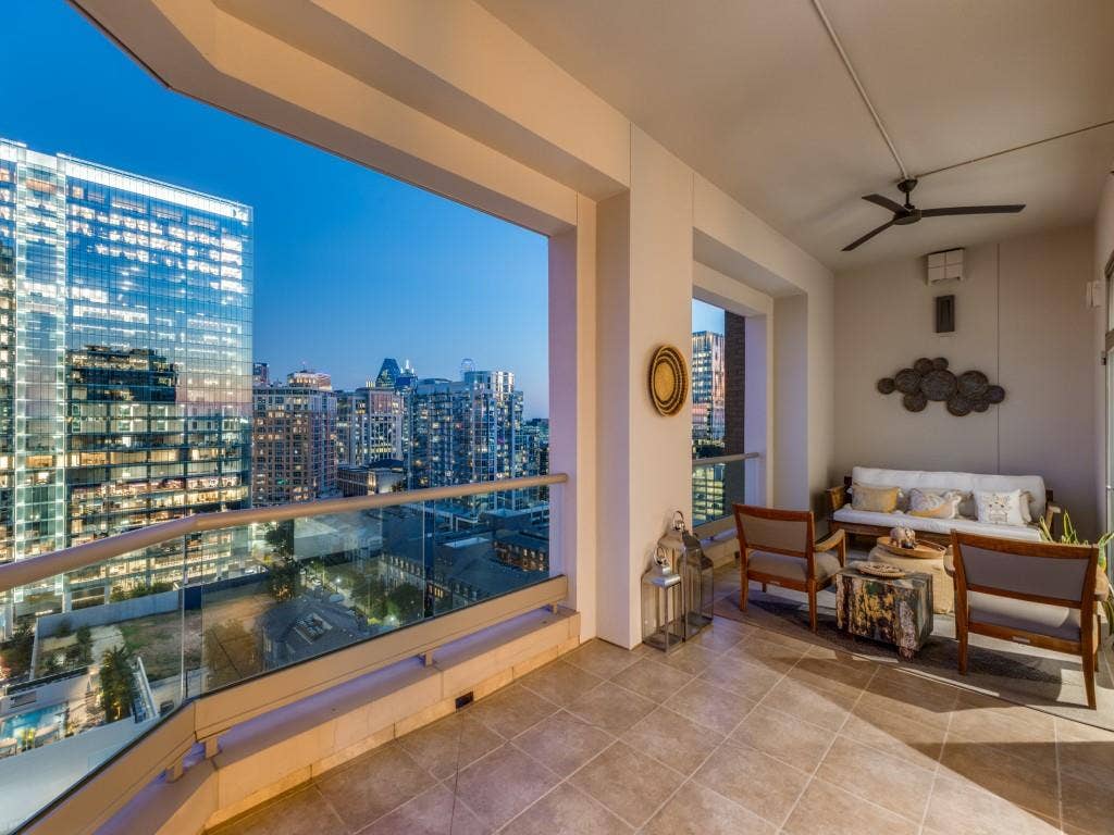 2300 Wolf Street, #14A, Dallas, TX 75201 Expansive balcony featuring a glass railing, tiled flooring, a built-in ceiling fan, and recessed lighting